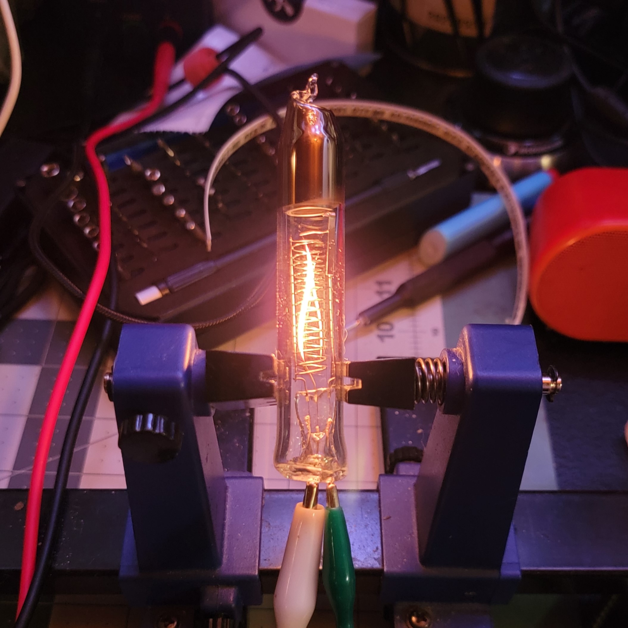 Close-up of the tube in a test stand with a glowing filament